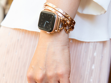 Load image into Gallery viewer, Woman with wrist by side, showing rose gold apple watch with Goldenerre rose gold classic link bracelet and two rose gold rhinestone bangles